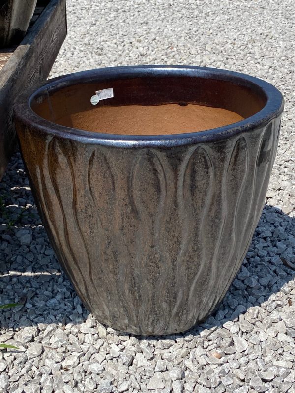 Large brown, gray and neutral tones flower pot with vertical pattern. Displayed on a gravel pad at Full Features Garden Center.