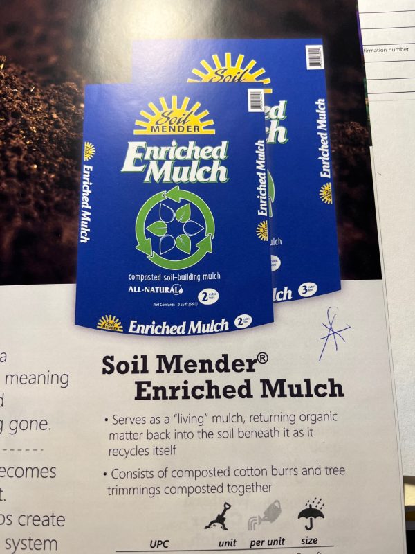 Soil Mender Enriched Mulch bag cover with text describing the product as living mulch that returns organic matter back into the soil beneath as it recycles itself. Consists of cotton burrs and tree trimmings composted together.